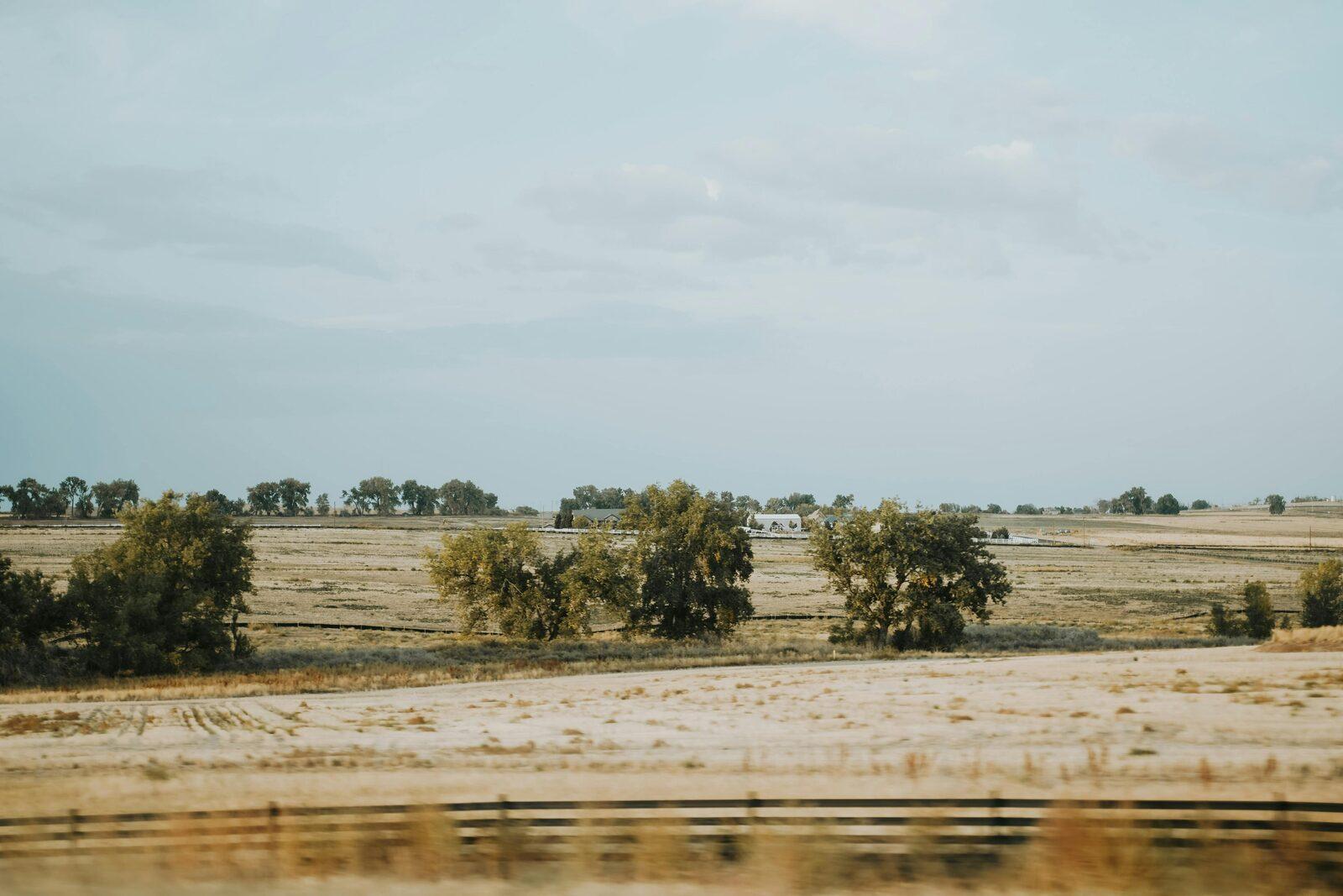 Original roadside rural property photo with a dull overcast sky.