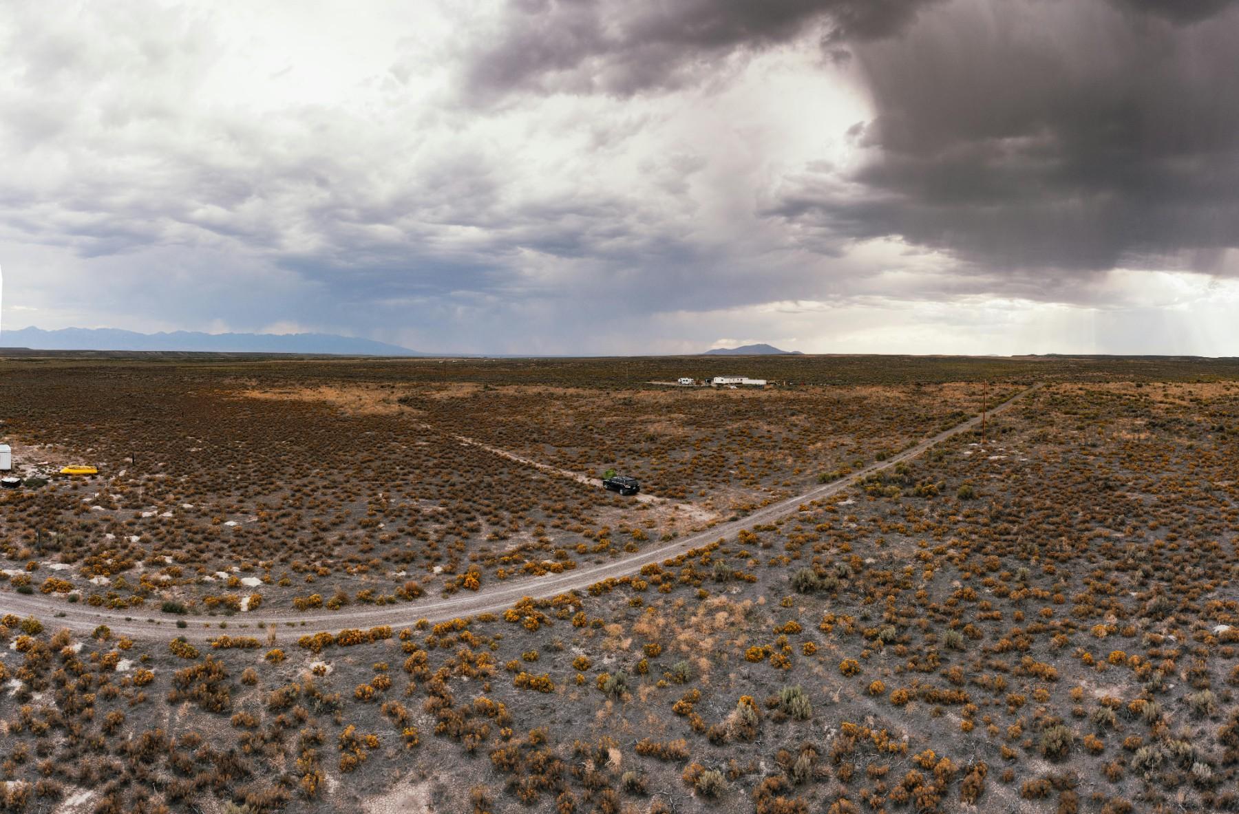 Original vacant desert land photo before solar farm concept visualization.